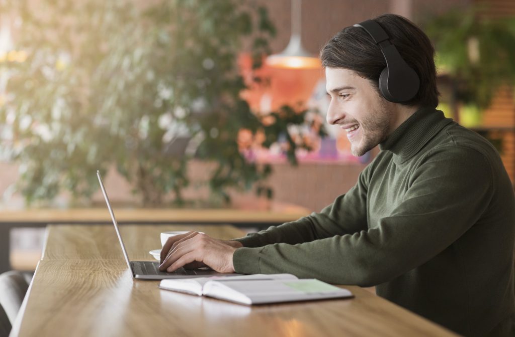 Modern businessman having skype conference on laptop